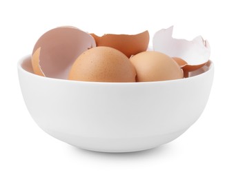 Photo of Broken eggshells in bowl isolated on white