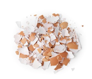 Photo of Pile of broken eggshells isolated on white, top view