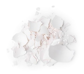 Photo of Pile of broken eggshells isolated on white, top view