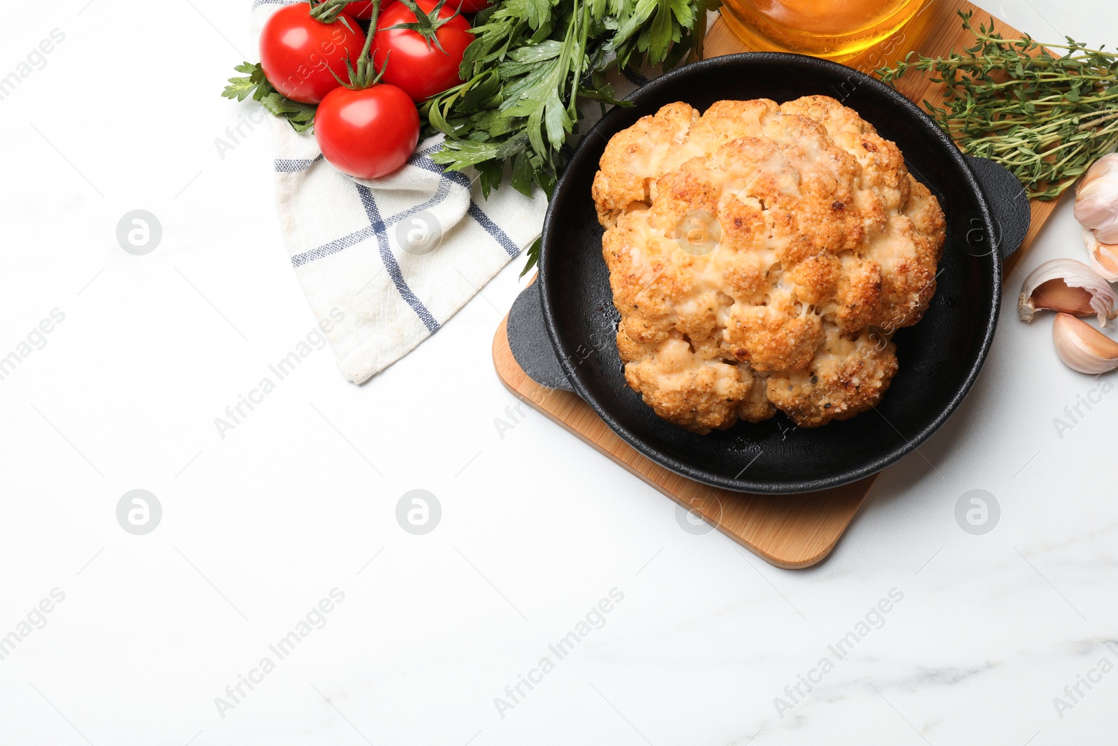 Photo of Delicious baked cauliflower in baking dish and products on white table, flat lay. Space for text