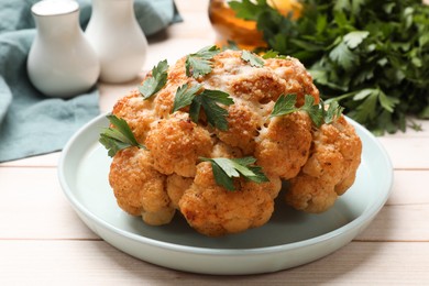 Photo of Delicious baked cauliflower with parsley on wooden table, closeup