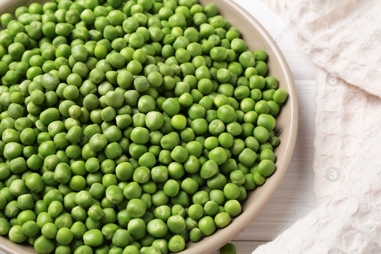 Photo of Fresh green peas on white wooden table, closeup