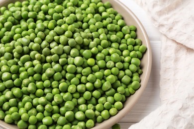 Fresh green peas on white wooden table, closeup