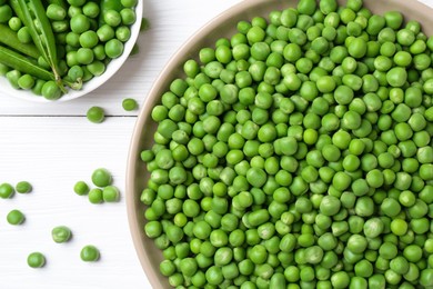 Photo of Fresh green peas and pods on white wooden table, flat lay