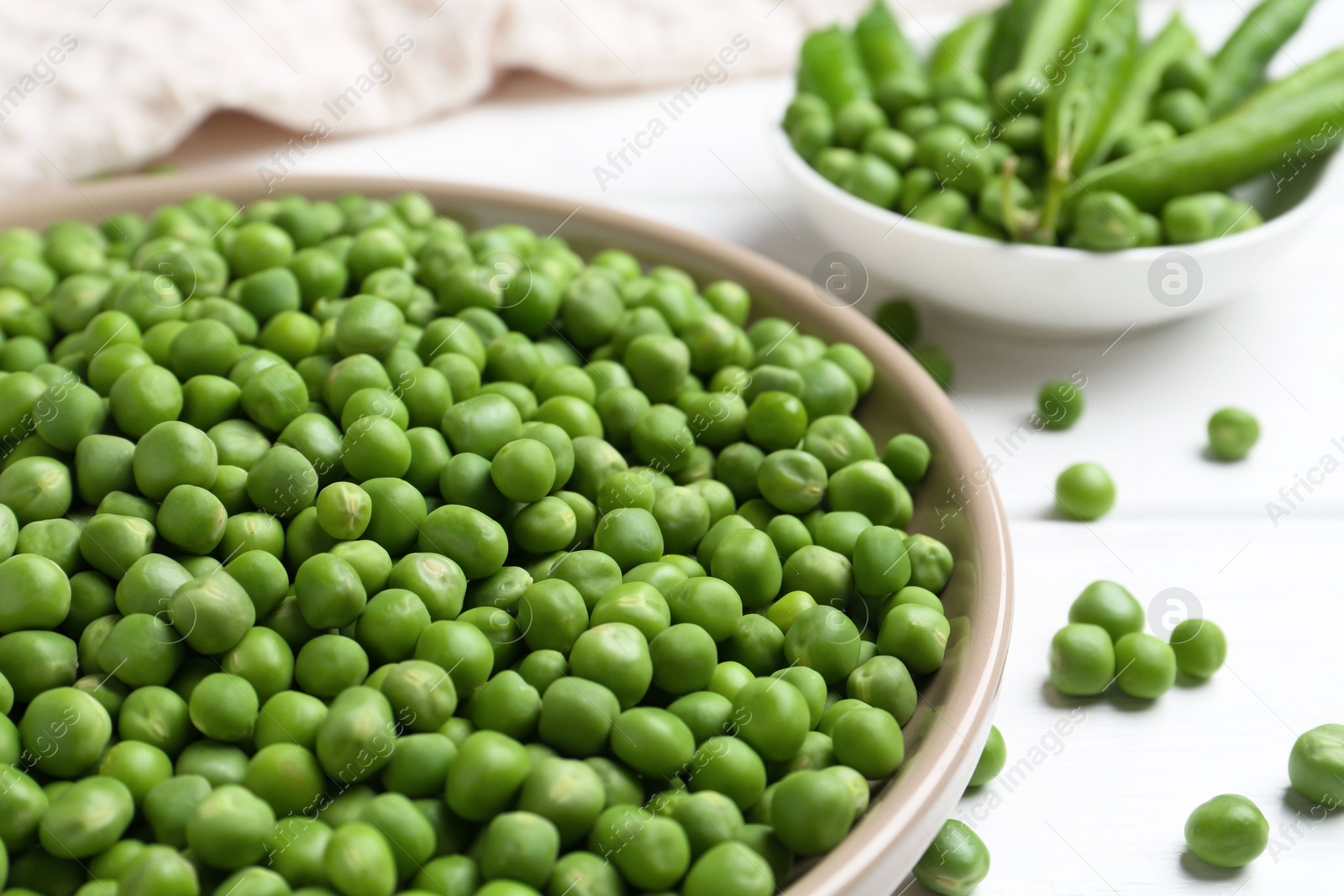 Photo of Fresh green peas and pods on white wooden table, closeup