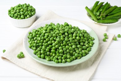 Photo of Fresh green peas and pods on white wooden table