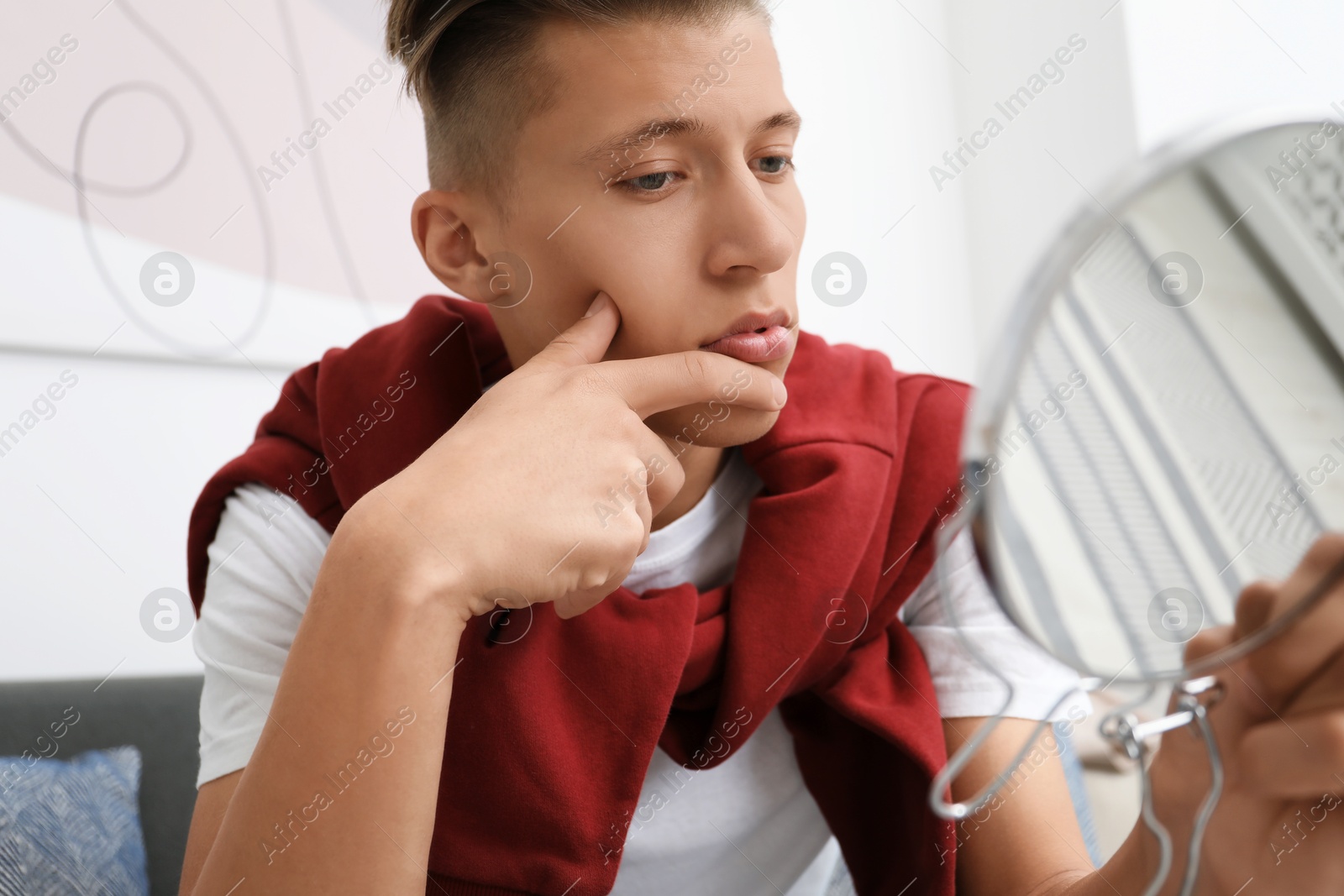 Photo of Handsome man looking at mirror at home