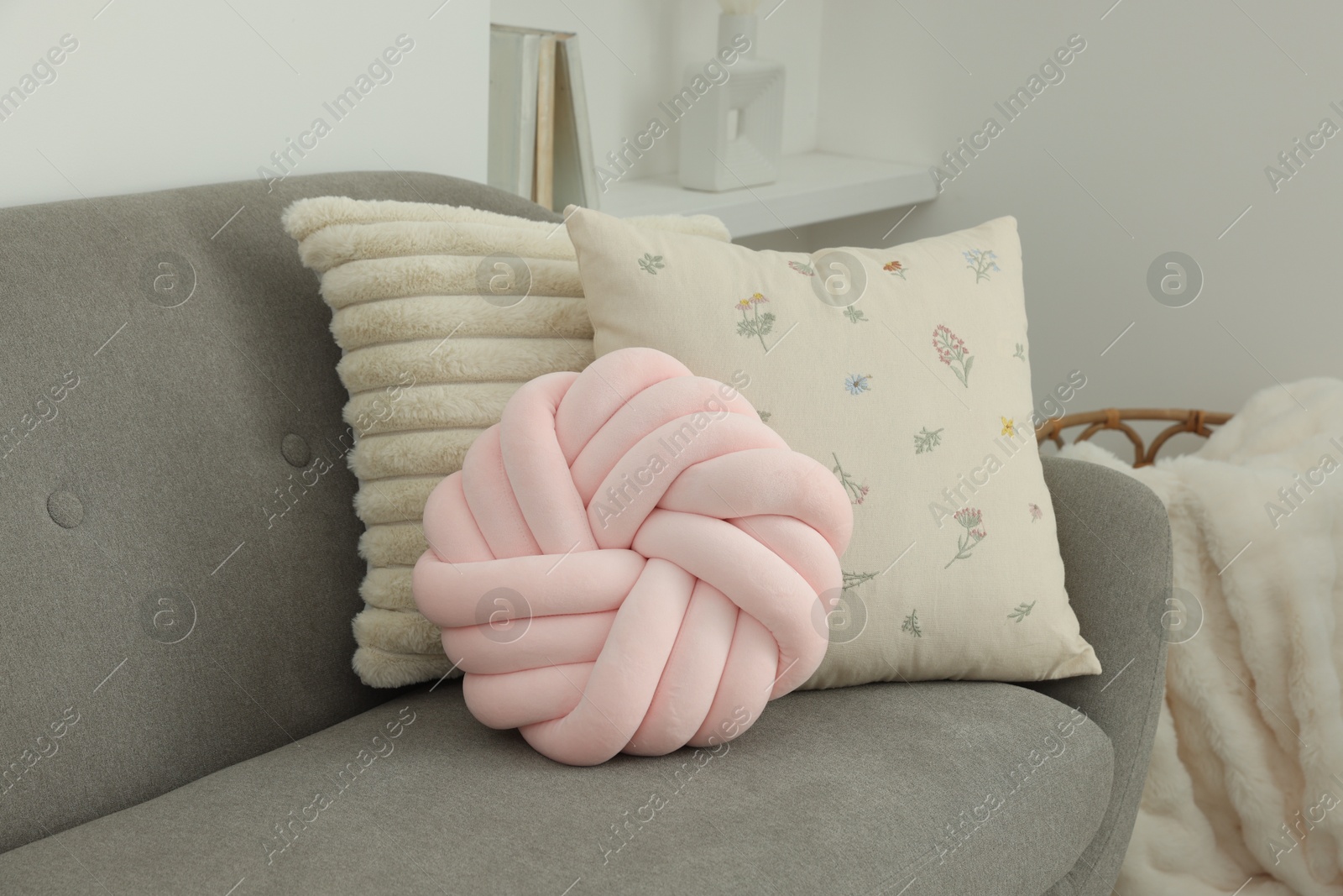 Photo of Different soft pillows on sofa in room