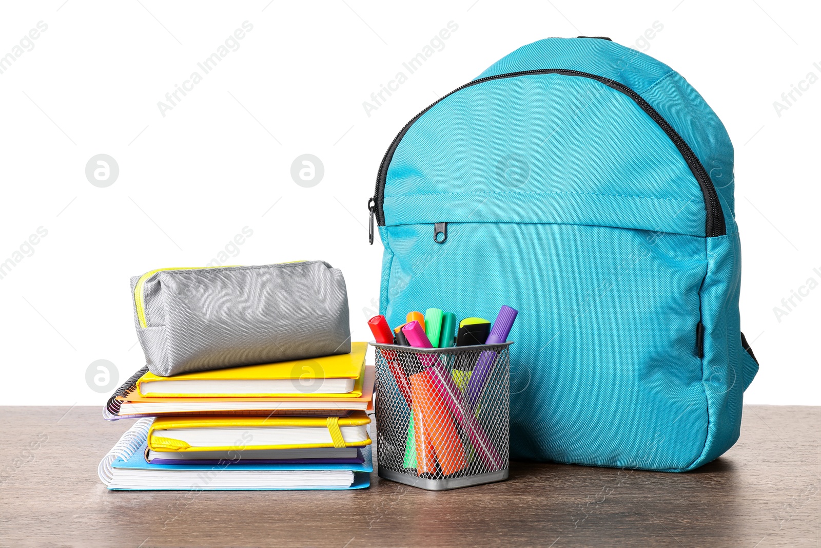 Photo of Backpack with different school stationery on wooden table against white background