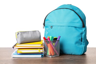 Photo of Backpack with different school stationery on wooden table against white background