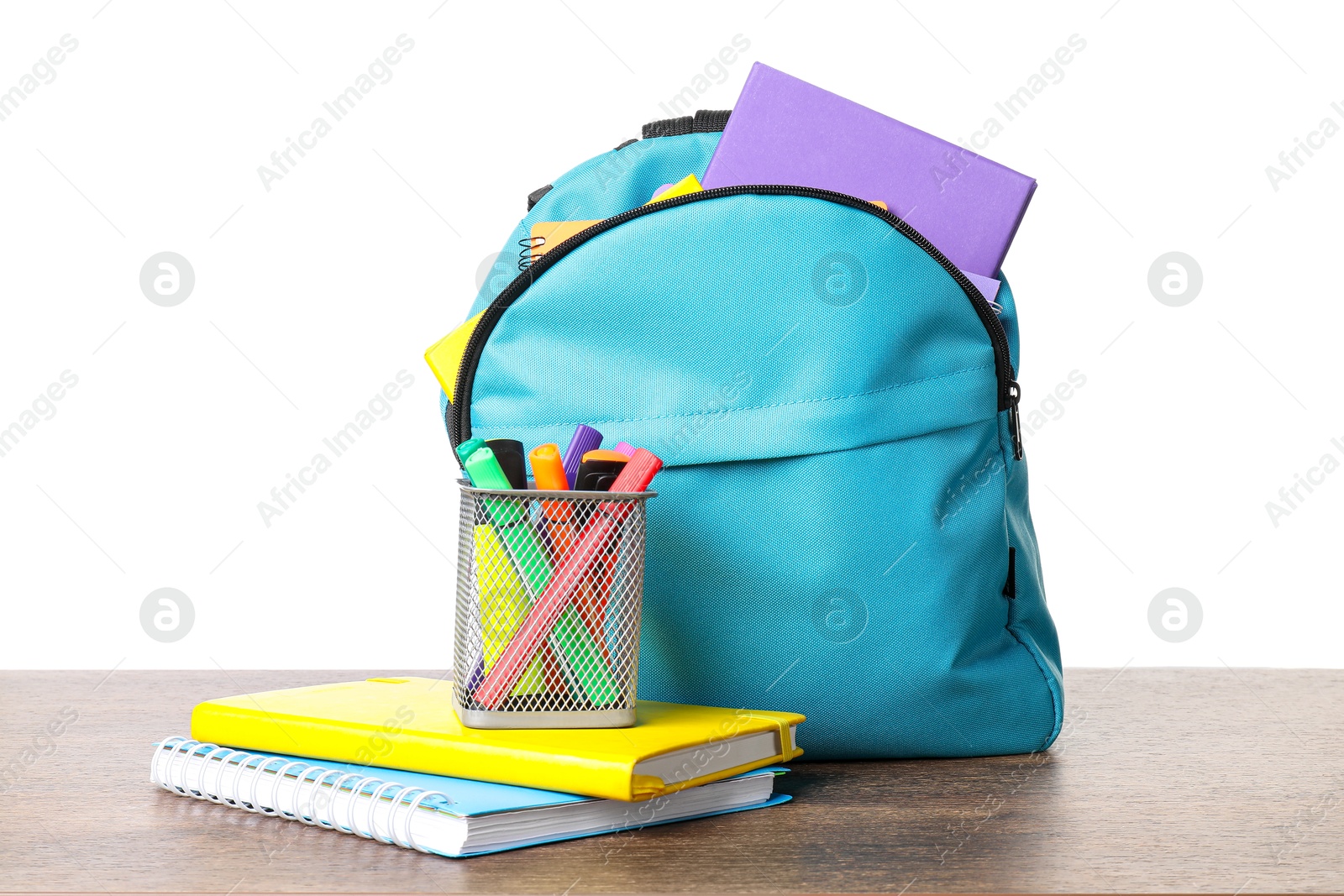 Photo of Backpack with different school stationery on wooden table against white background