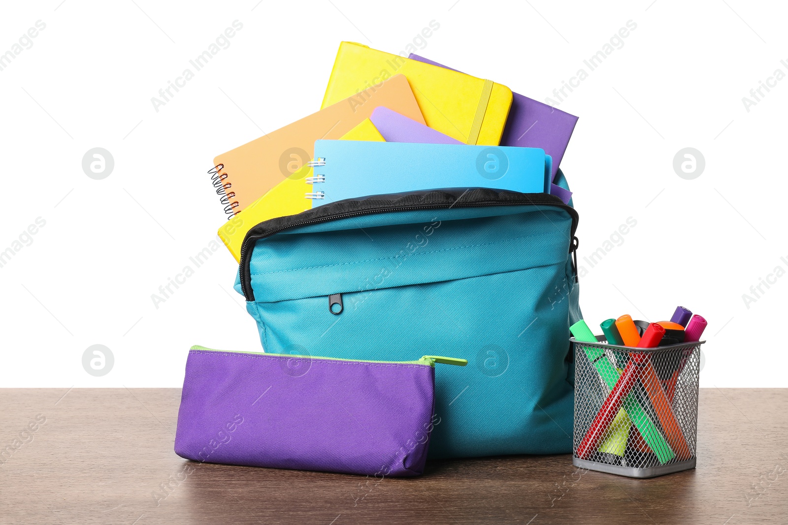 Photo of Backpack with different school stationery on wooden table against white background