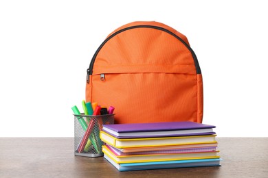 Photo of Backpack with different school stationery on wooden table against white background