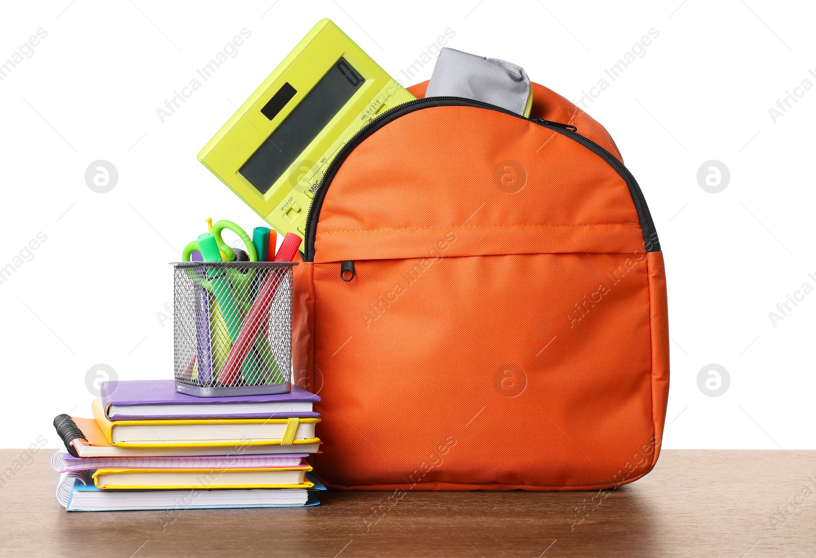 Photo of Backpack with different school stationery on wooden table against white background