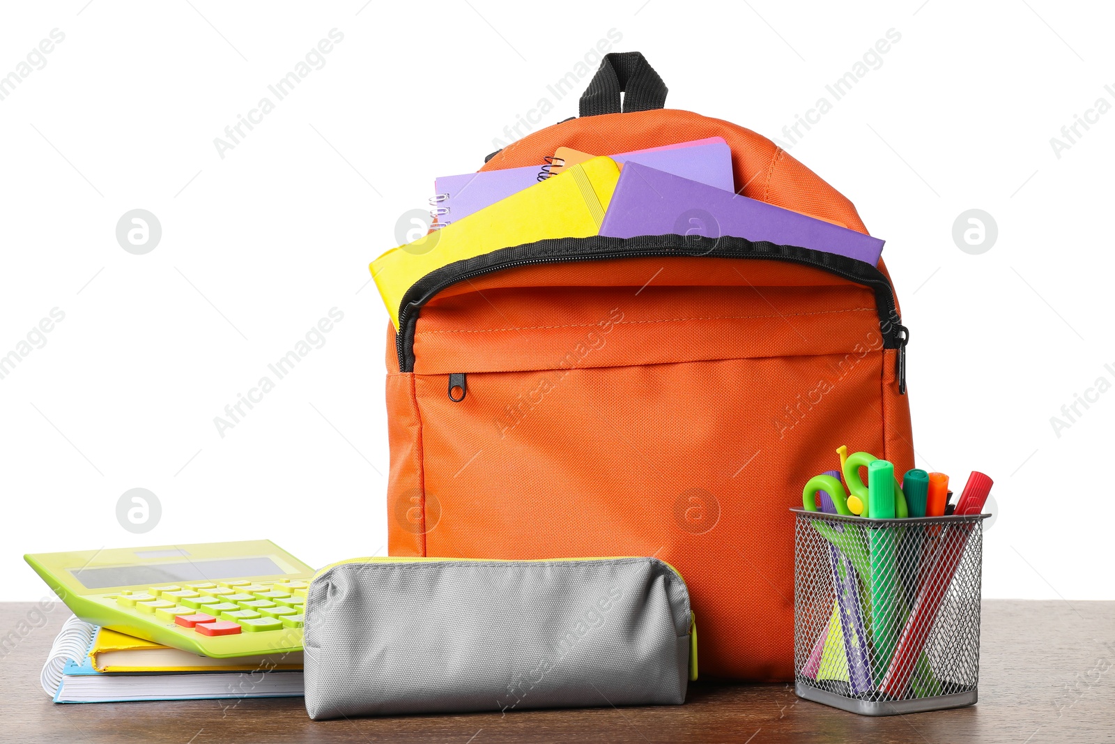 Photo of Backpack with different school stationery on wooden table against white background