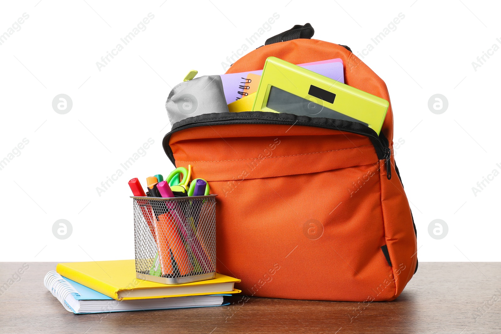 Photo of Backpack with different school stationery on wooden table against white background