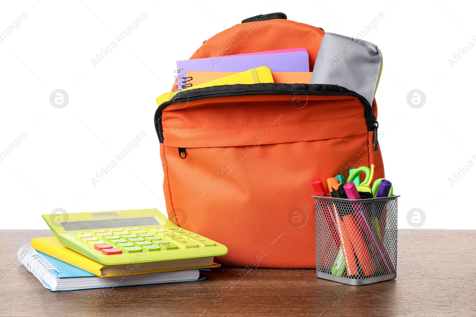 Photo of Backpack with different school stationery on wooden table against white background