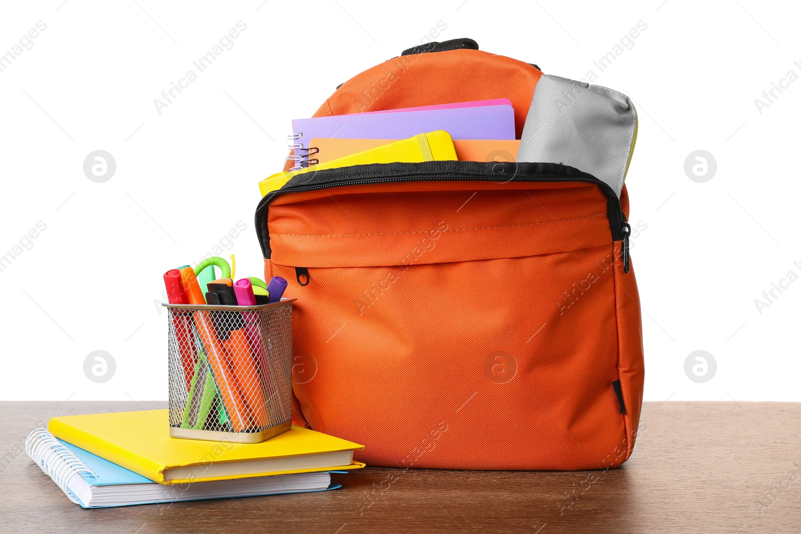 Photo of Backpack with different school stationery on wooden table against white background