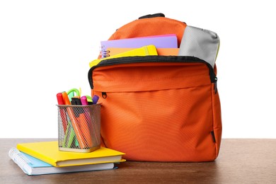 Backpack with different school stationery on wooden table against white background