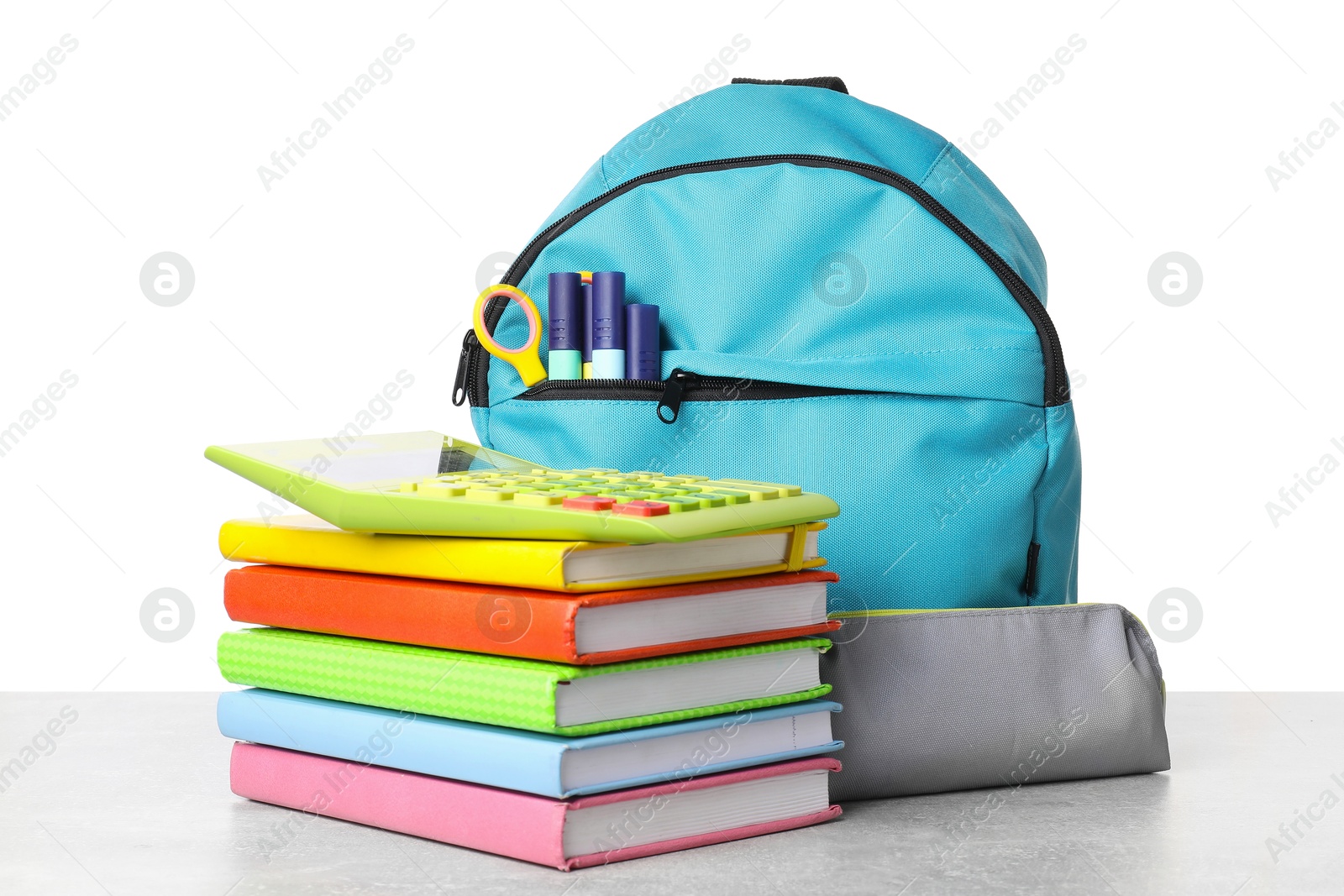 Photo of Backpack with different school stationery on light grey table against white background