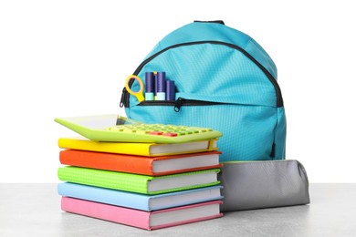 Photo of Backpack with different school stationery on light grey table against white background