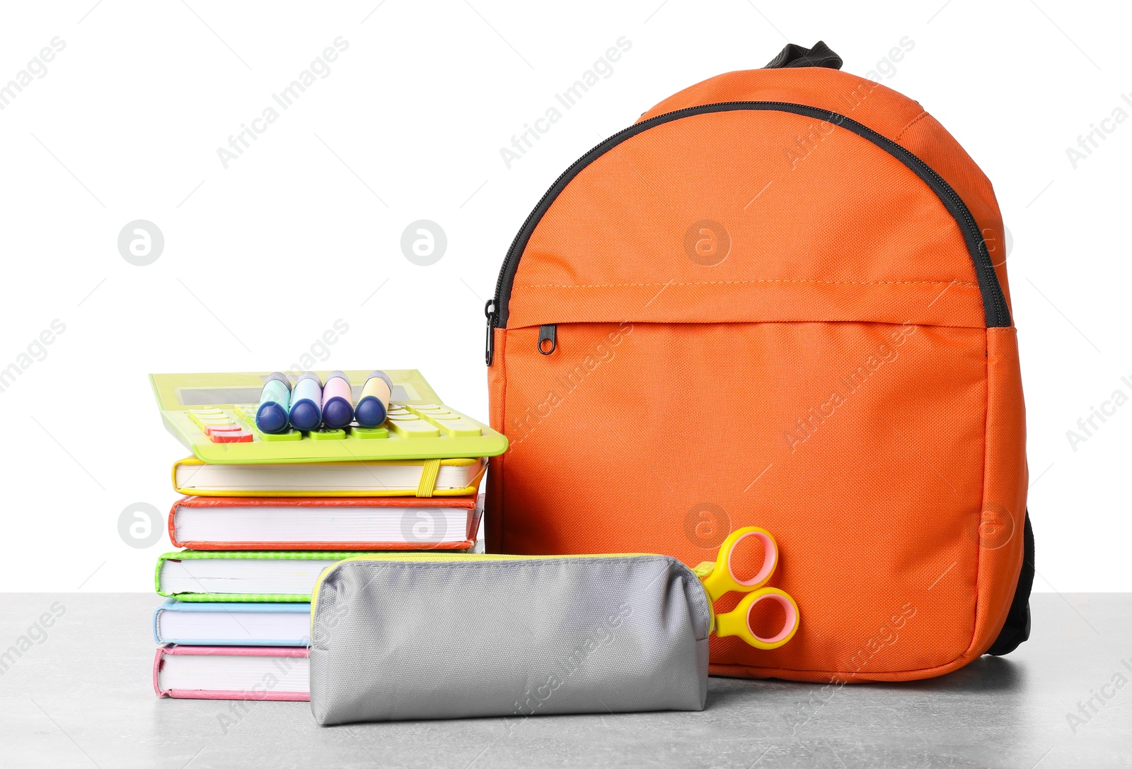 Photo of Backpack with different school stationery on light grey table against white background