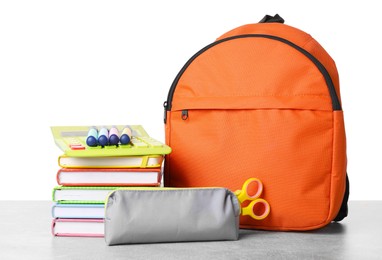 Photo of Backpack with different school stationery on light grey table against white background