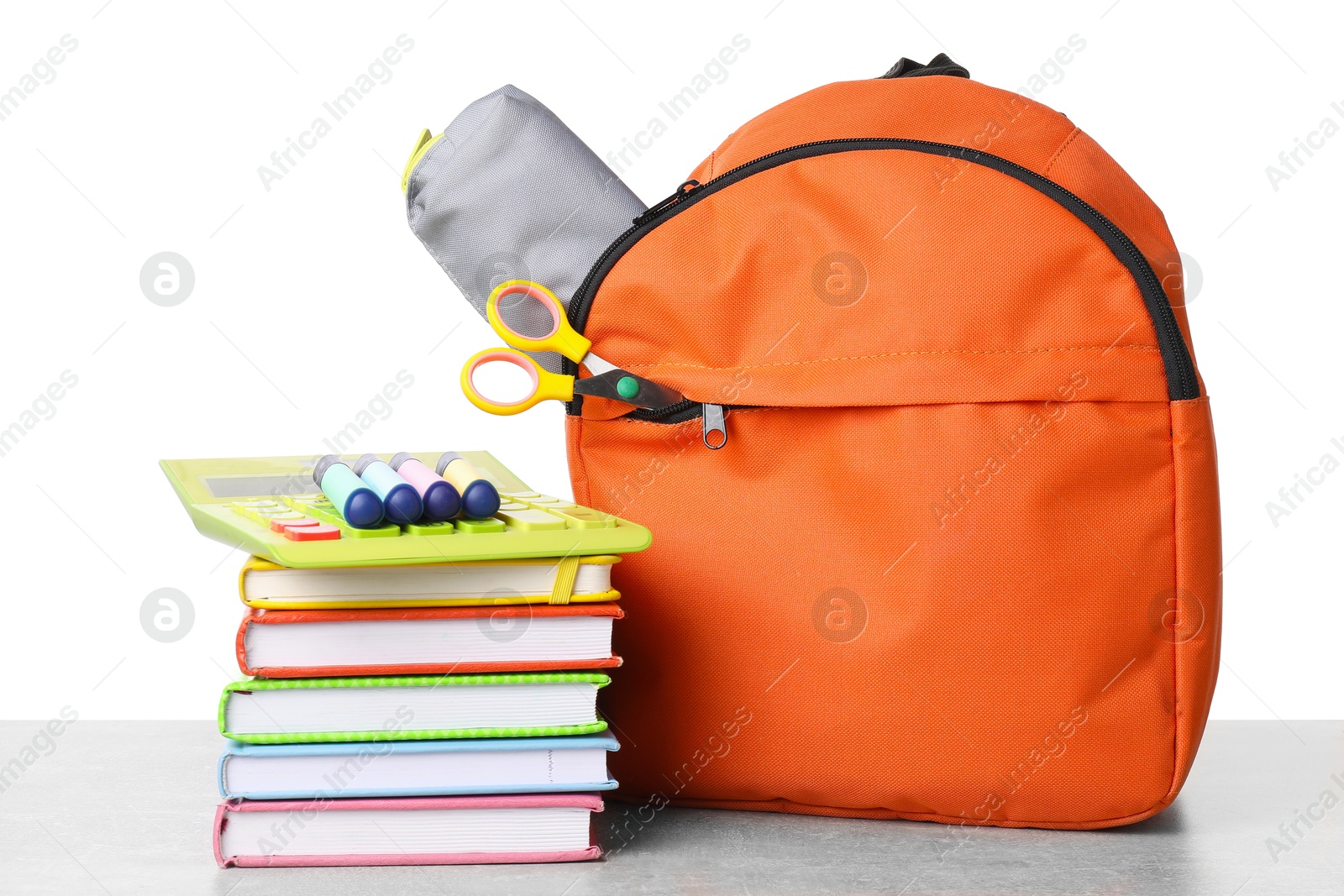 Photo of Backpack with different school stationery on light grey table against white background