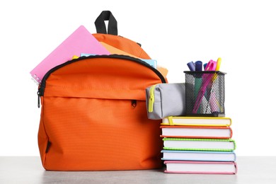 Photo of Backpack with different school stationery on light grey table against white background