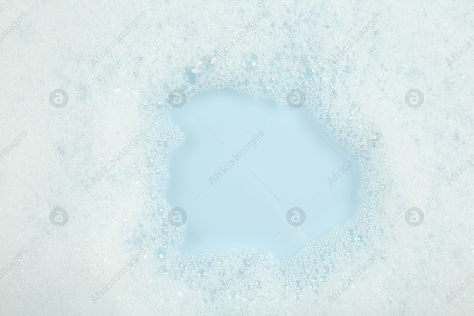 Photo of Washing laundry. Water with foam, top view