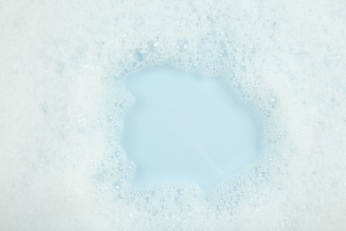 Photo of Washing laundry. Water with foam, top view