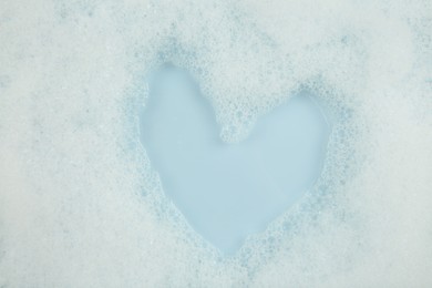 Washing laundry. Water with foam, top view