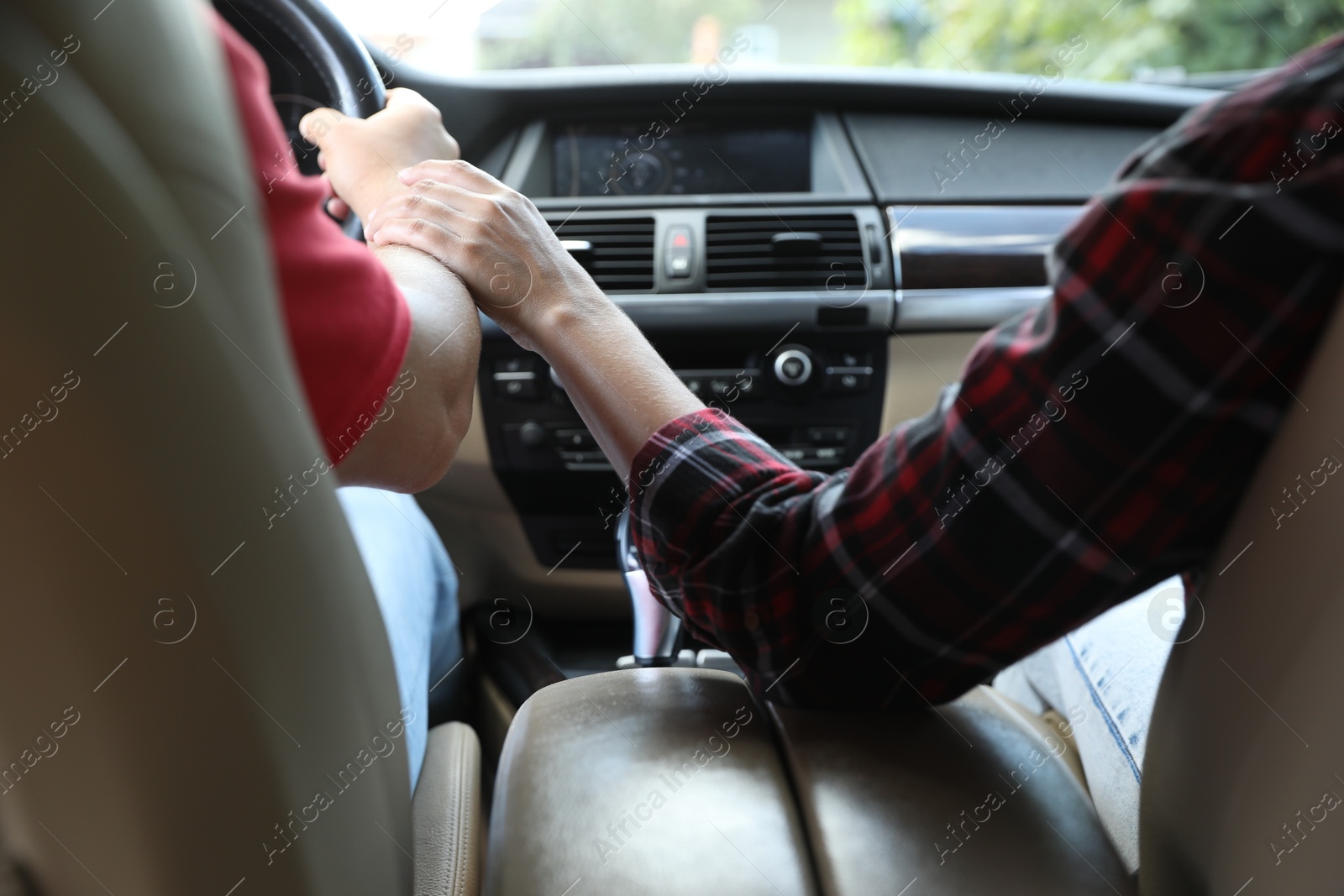 Photo of Lovely couple holding hands together while traveling by car, closeup