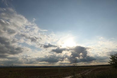 Photo of Sun shining through clouds on beautiful sky