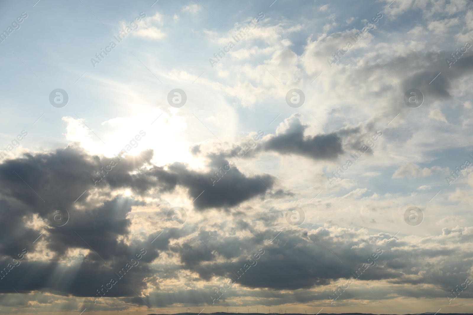 Photo of Sun shining through clouds on beautiful sky