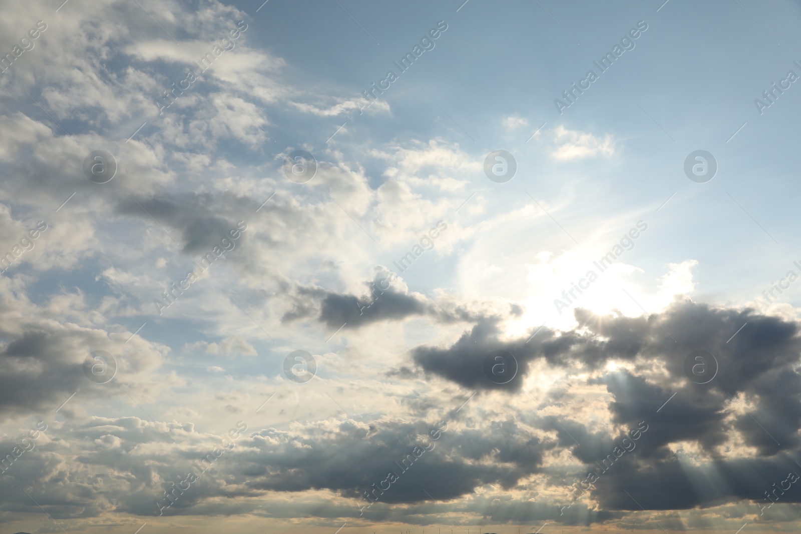 Photo of Sun shining through clouds on beautiful sky