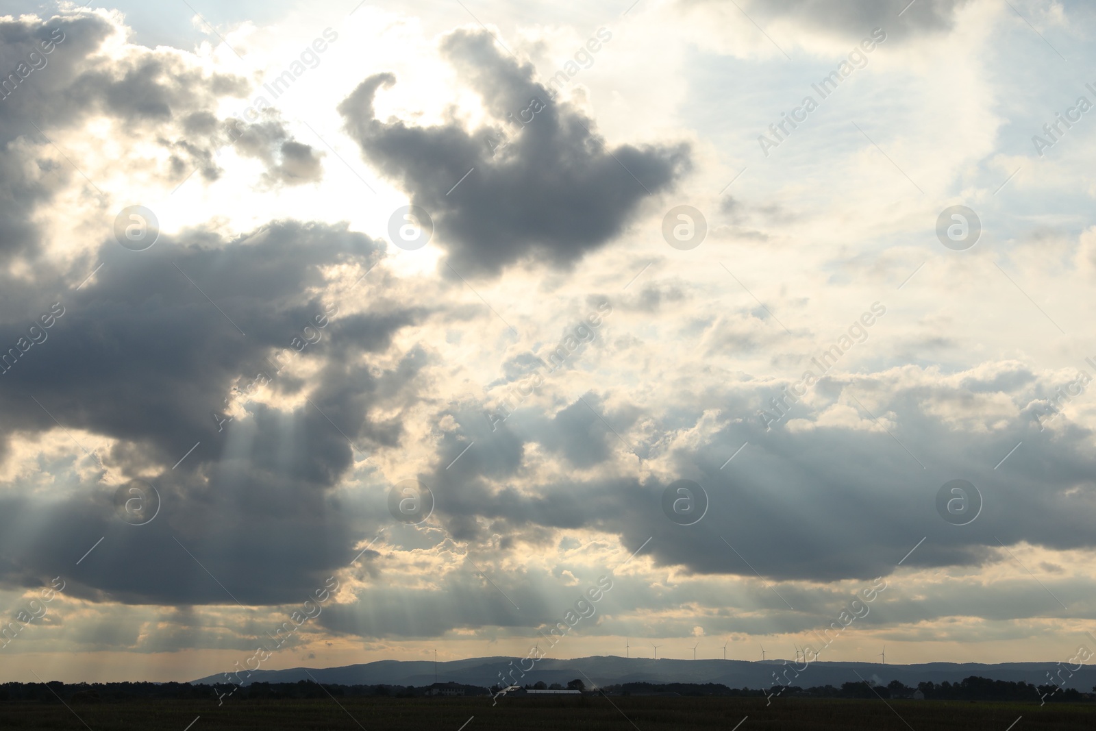 Photo of Sun shining through clouds on beautiful sky