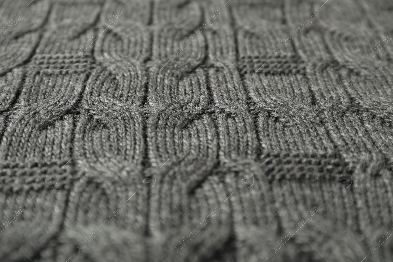 Photo of Texture of grey knitted fabric as background, closeup