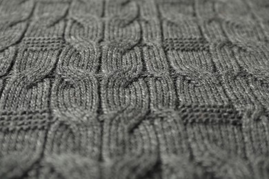 Texture of grey knitted fabric as background, closeup