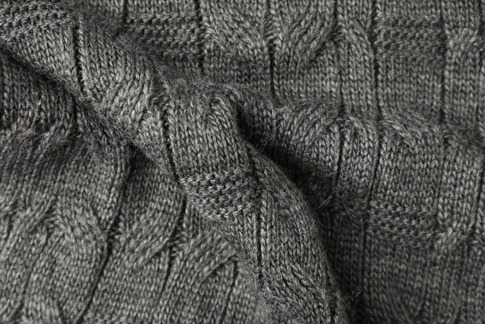 Photo of Texture of grey knitted fabric as background, top view