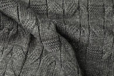 Photo of Texture of grey knitted fabric as background, top view