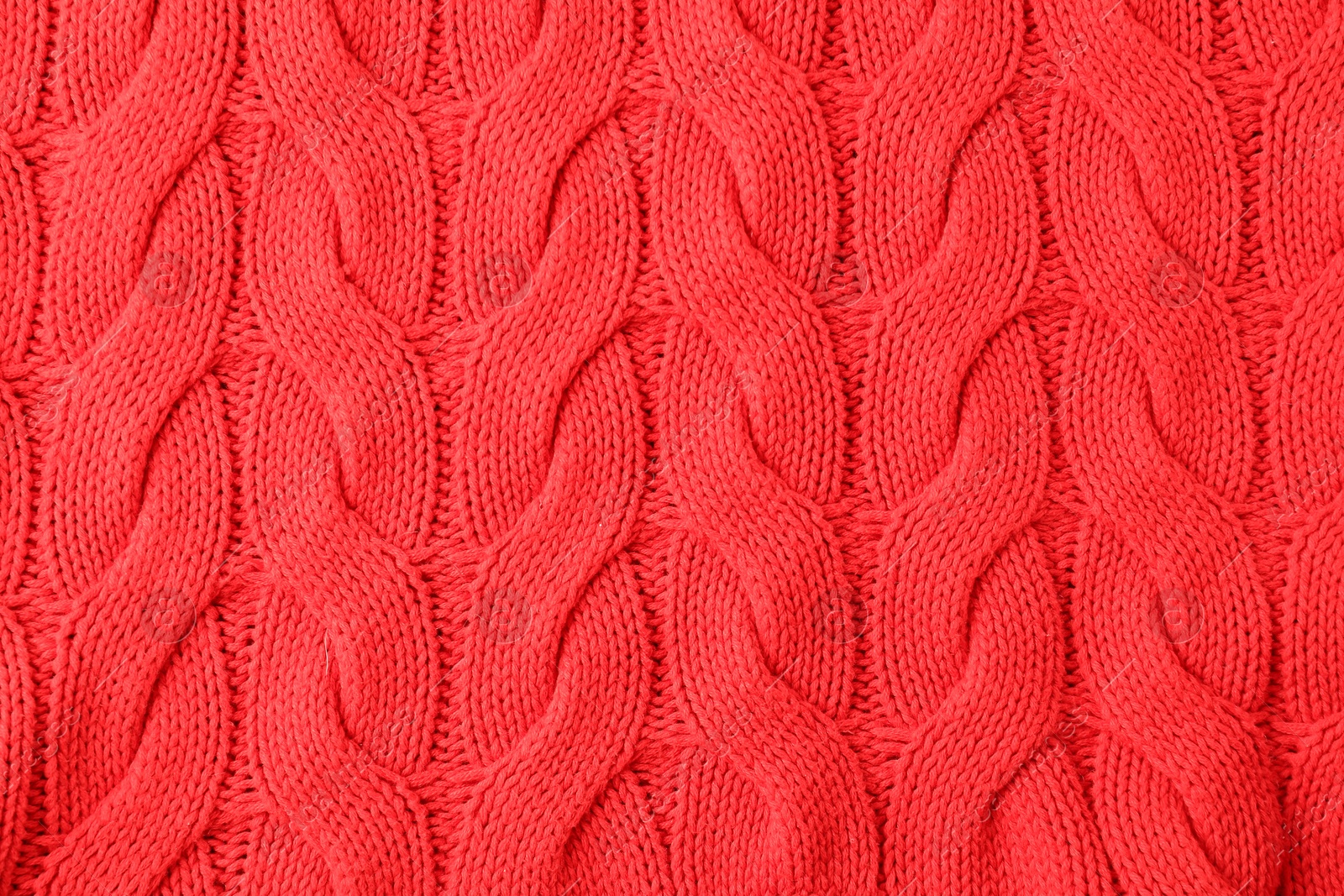 Photo of Texture of red knitted fabric as background, top view