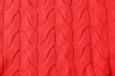 Photo of Texture of red knitted fabric as background, top view