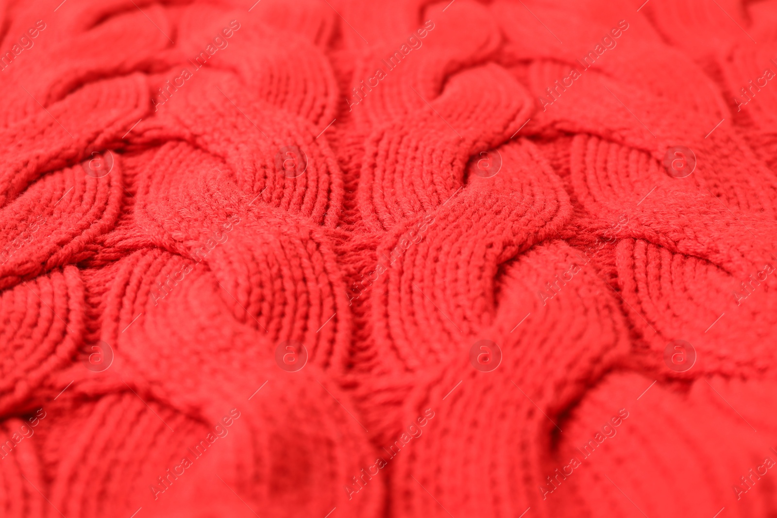 Photo of Texture of red knitted fabric as background, closeup