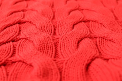 Texture of red knitted fabric as background, closeup