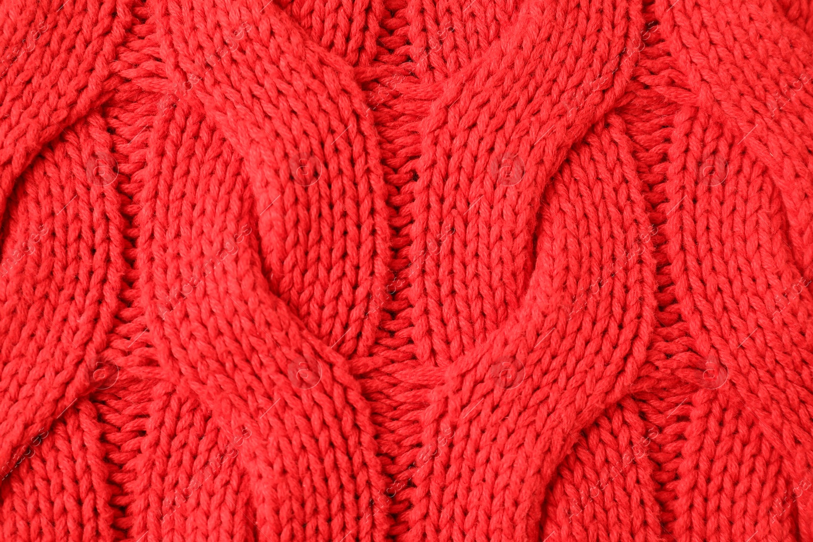 Photo of Texture of red knitted fabric as background, top view