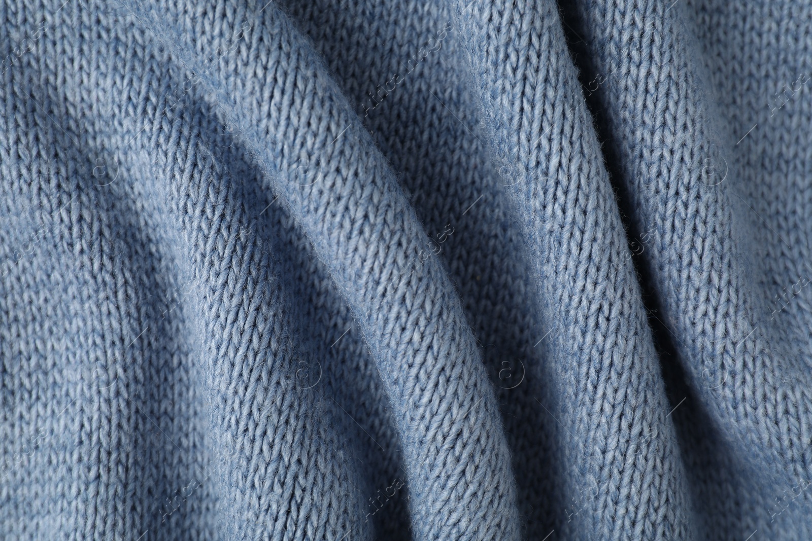 Photo of Texture of blue knitted fabric as background, top view