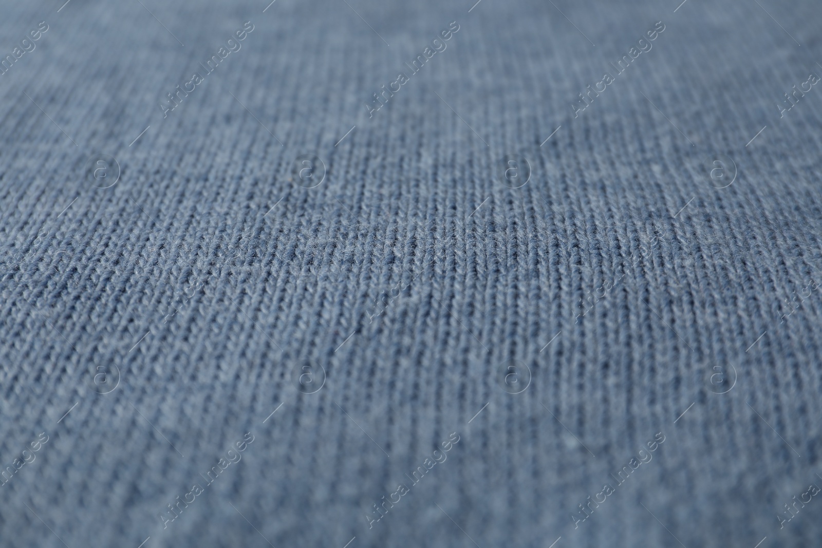 Photo of Texture of blue knitted fabric as background, closeup