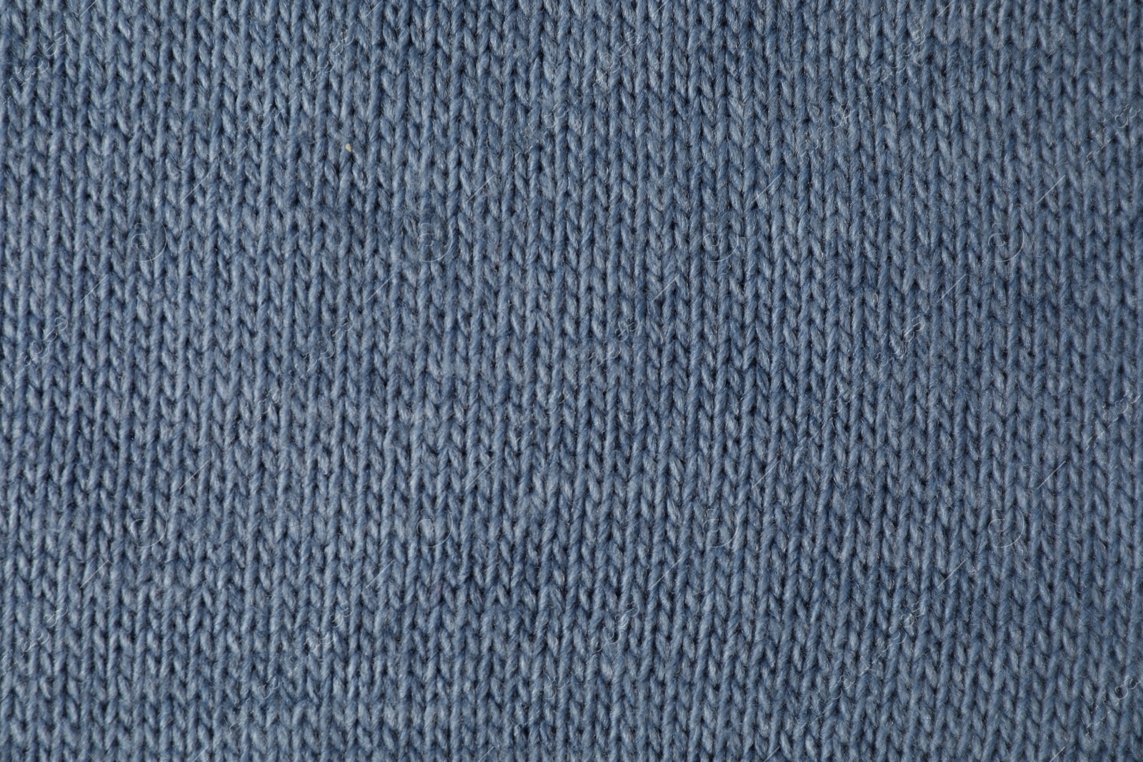 Photo of Texture of blue knitted fabric as background, top view