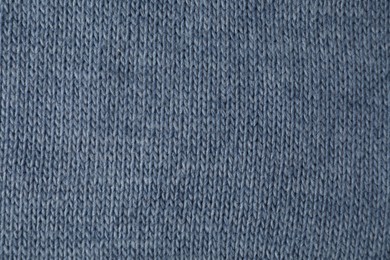 Texture of blue knitted fabric as background, top view